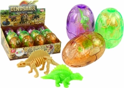 Liela caurspīdīga dinozaura oliņa ar 2 figūriņām, 9 cm