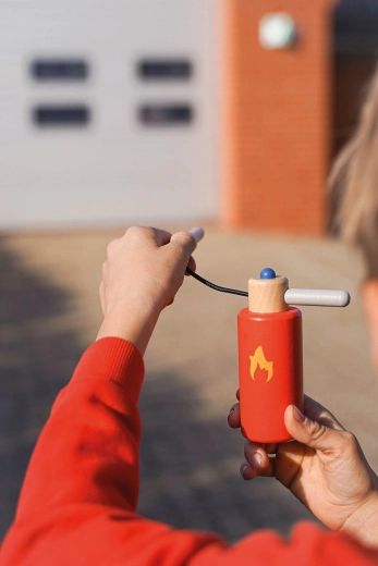 Fire extinguisher as an essential part of a little firefighter’s gear