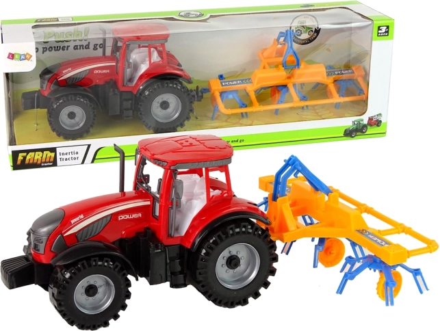 Sarkans traktors ar grābekli ar frikcijas piedziņu